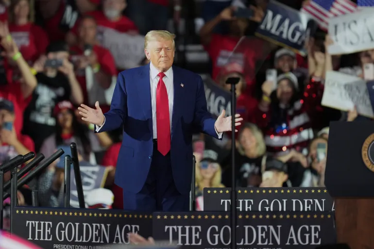 US President Donald Trump arrives to speak on his first 100 days at Macomb County Community College Sports Expo Center, Tuesday, April 29, 2025, in Warren, Michigan