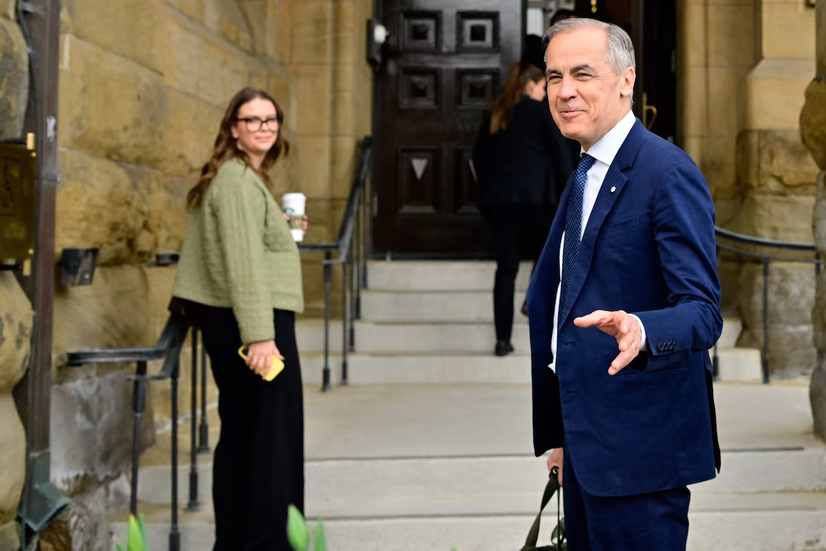 Canada's Prime Minister Mark Carney gestures as he walks into his office after the Liberal Party staged a major political comeback to retain power in parliamentary elections, in Ottawa, Ontario, Canada April 29, 2025.