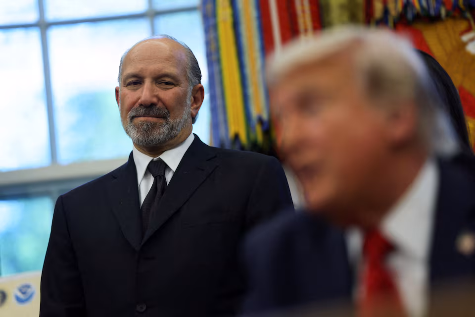 .S. Secretary of Commerce Howard Lutnick listens to U.S. President Donald Trump speak during an even to to sign executive orders in the Oval Office at the White House in Washington, D.C., U.S., April 23, 2025