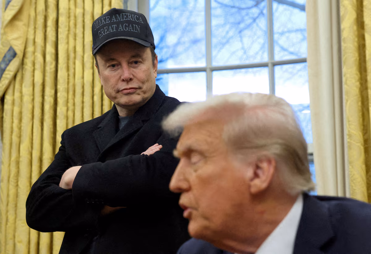 Elon Musk listens to U.S. President Donald Trump speak in the Oval Office of the White House in Washington, D.C., U.S., February 11, 2025.