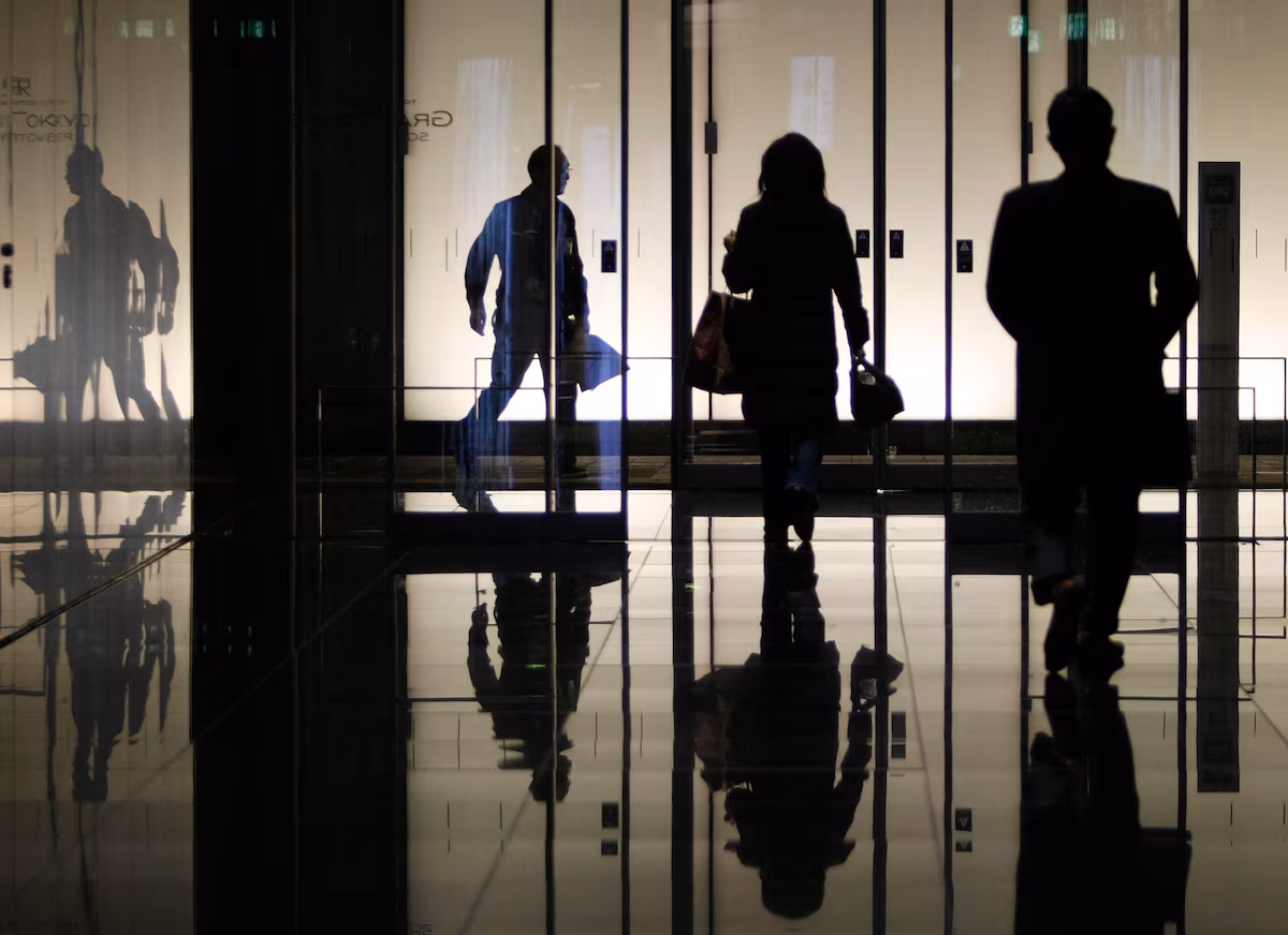 Pedestrians walk through an office building in Tokyo January 8, 2009.