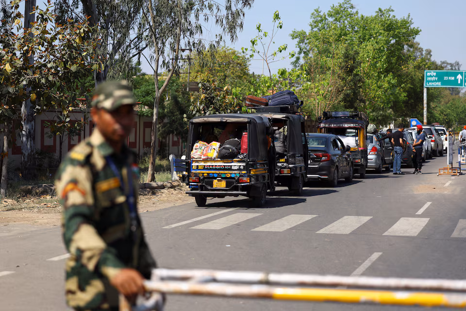 A military personnel with the Border Security Force (BSF) stands guard, as vehicles having Pakistani citizens line up near the Integrated check post, as they prepare to leave India after India revoked visas issued to Pakistani citizens, at the Attari-Wagah border crossing near Amritsar, India, April 27, 2025.