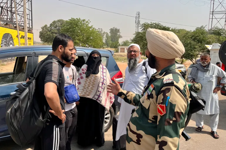 Haleema Begum, 48, in the middle, with her sons on the left, at the Attari-Wagah border crossing. Haleema, a Pakistani national, had to leave India, along with her Indian sons