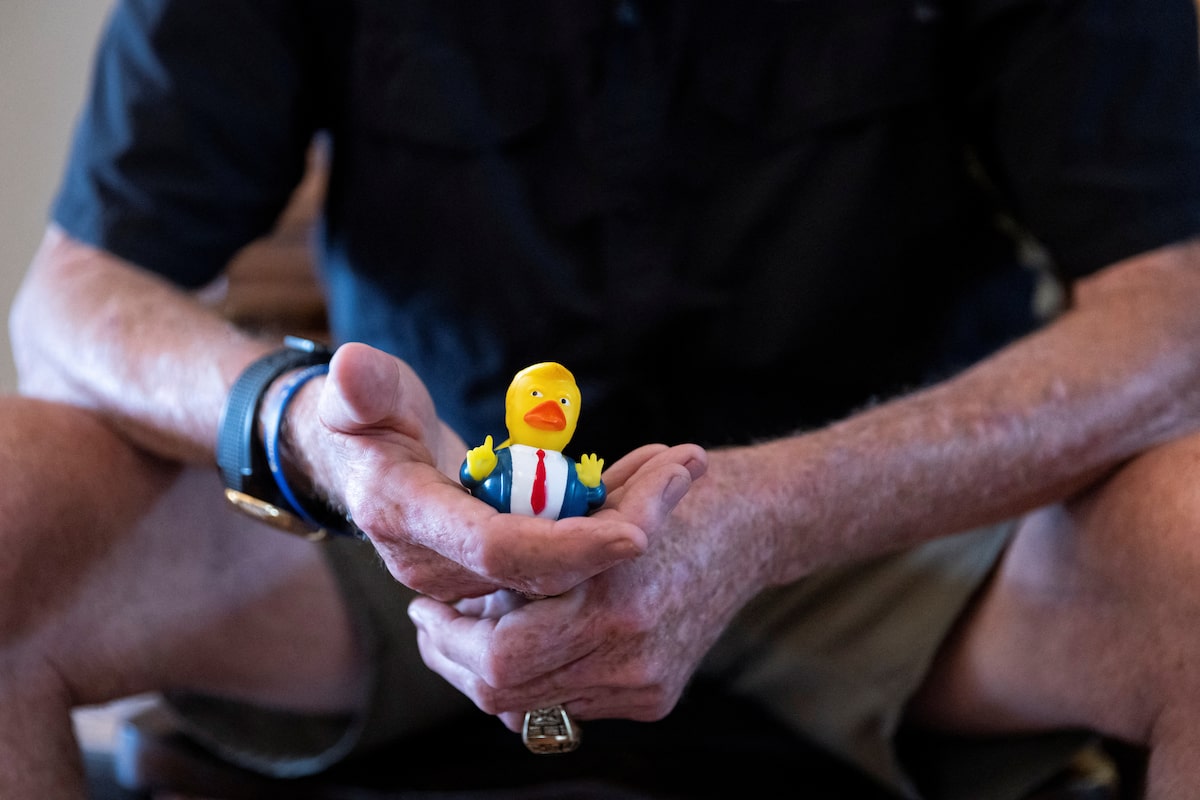 Steve Egan, owner of a custom promotional items business, holds a U.S. President Donald Trump-themed rubber duck as he poses for a portrait during an interview with Reuters in Brandon, Florida,