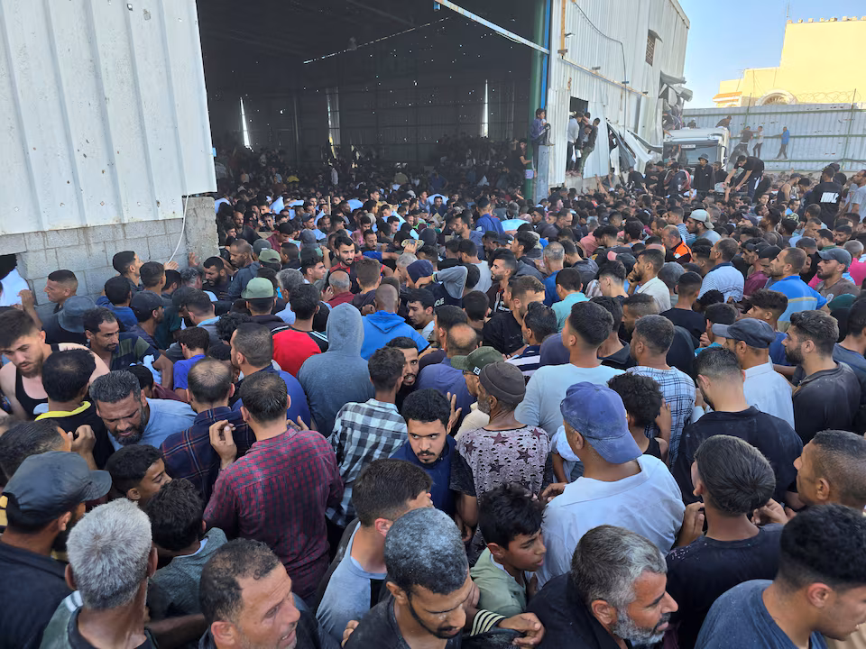 Aid Distribution in Gaza Falters as Desperate Crowds Raid Food Trucks